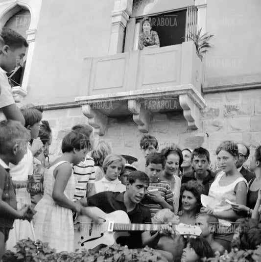 Adriano Celentano fa una serenata a Gina Lollobrigida, Festival di Venezia, 1962 - Farabola Immagine digitale